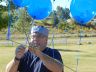 President Frank Everitt prepares the balloon line for the kids